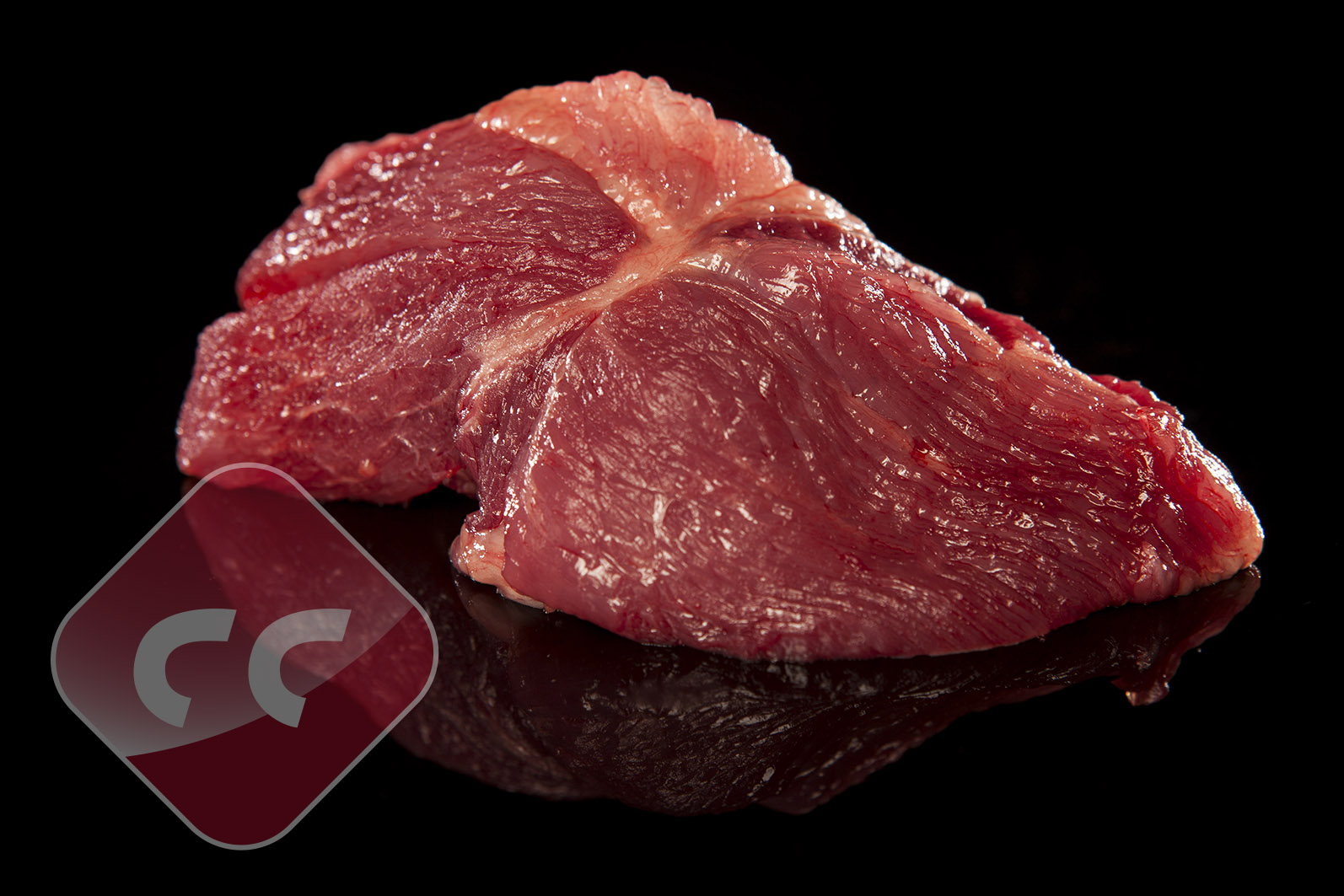 Fresh raw beef meat cut on black reflective surface for premium quality butcher meat product photography